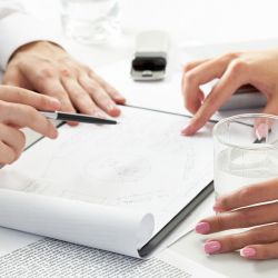 Close-up of team working with documents at business meeting